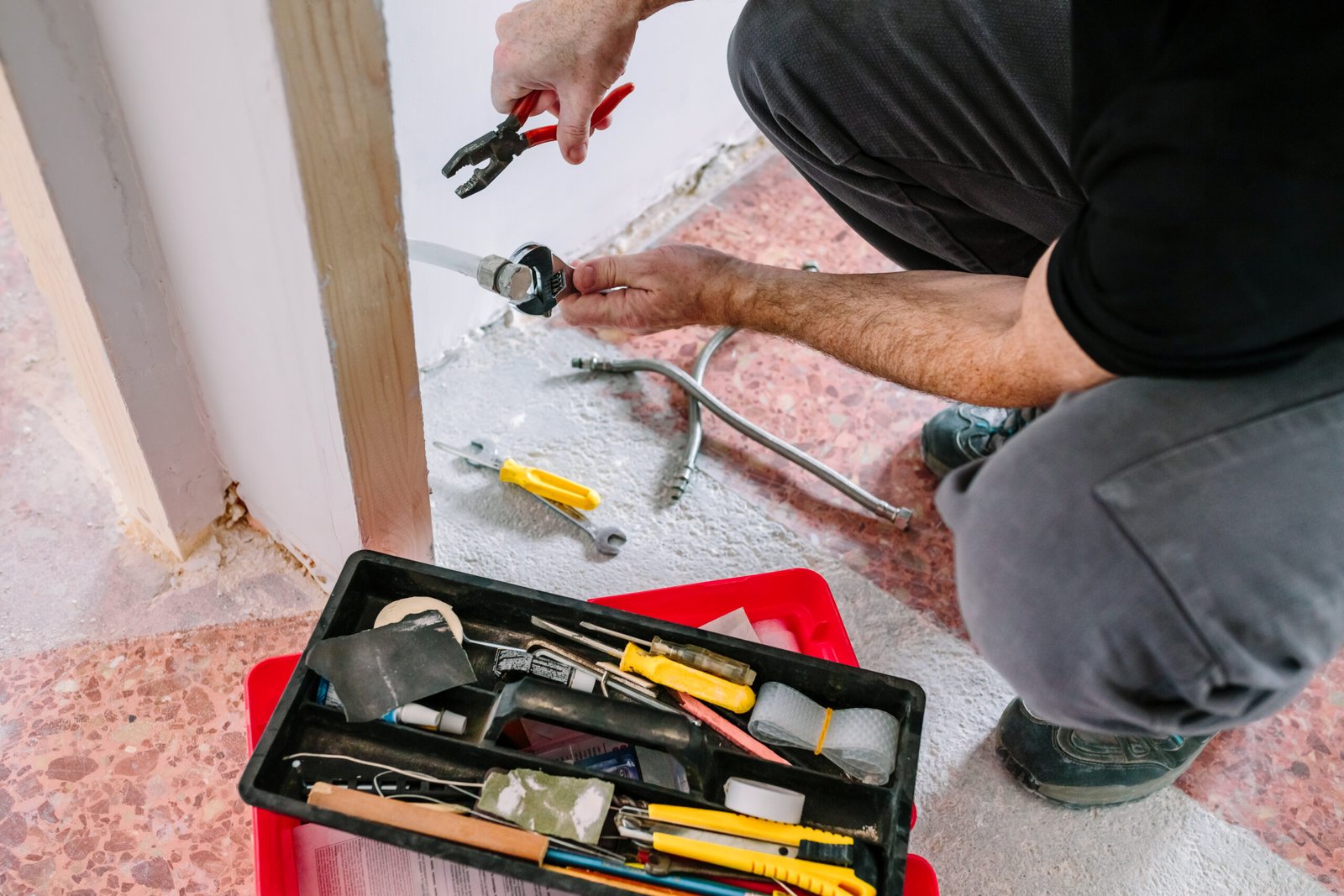 plumber doing heating installation construction site 1 scaled